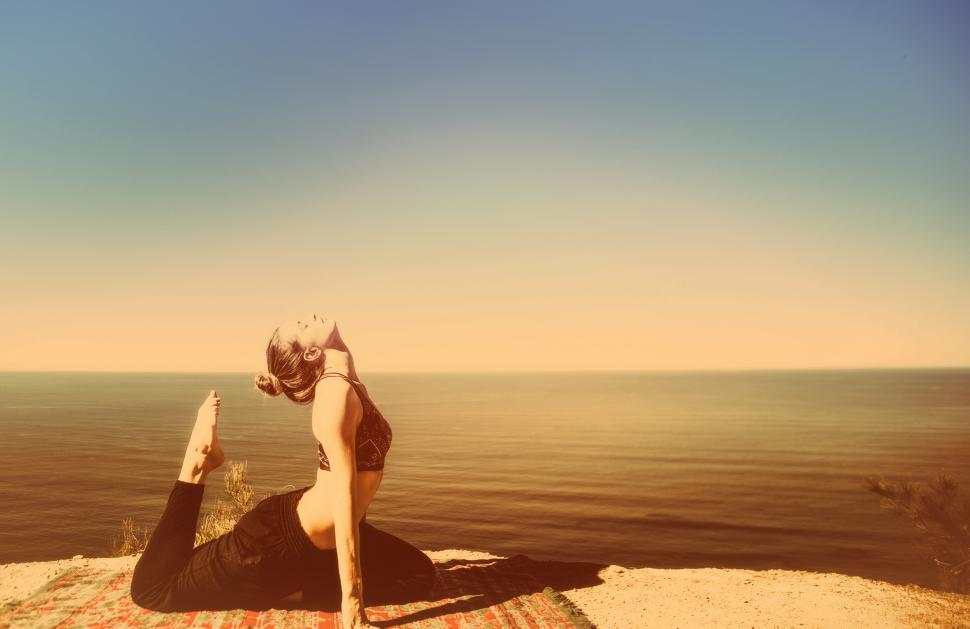 Free Image of Woman Practicing Yoga by the Ocean - Metal Toned 