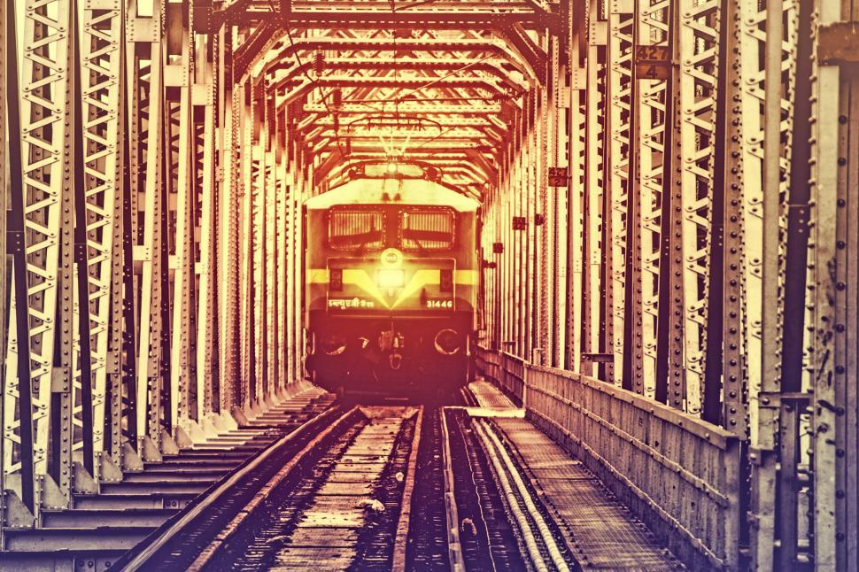 Free Image of Train Crossing Metal Bridge 