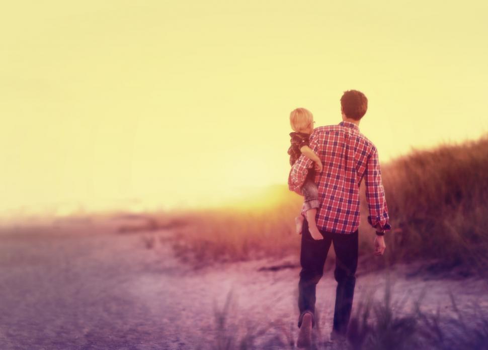 Free Image of Father Carrying His Baby on the Beach 