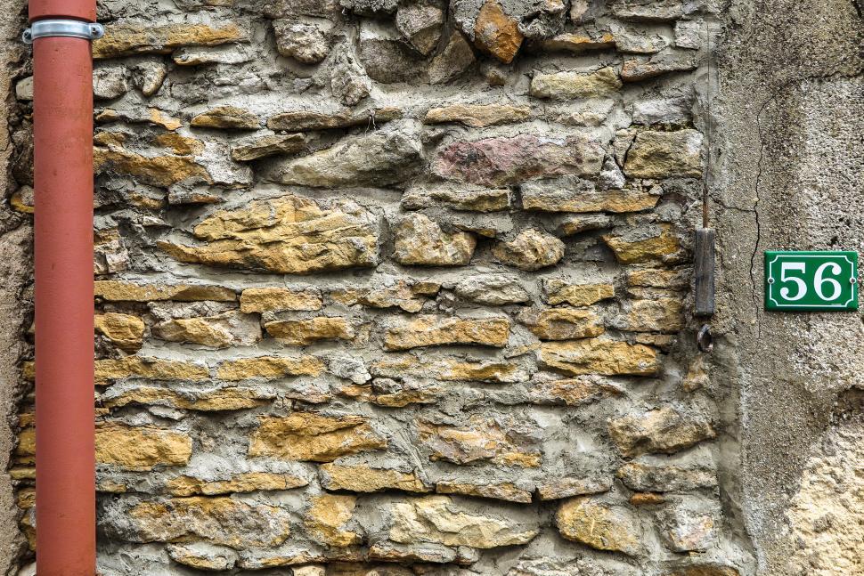 Free Image of Wall with address and pipe 