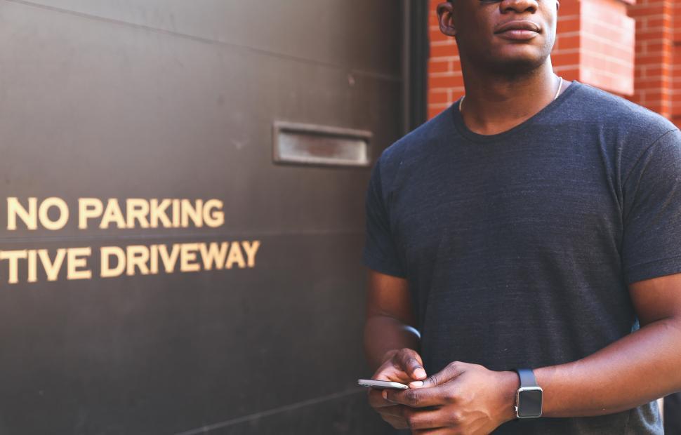 Free Image of Man standing by no parking area 