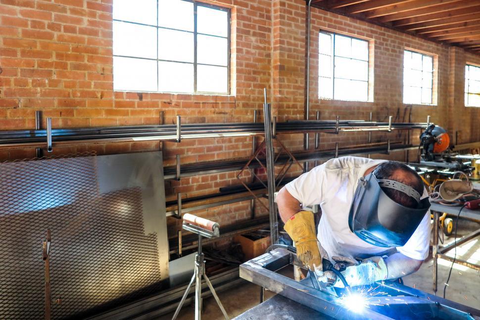 Free Image of Welder working in an industrial warehouse 