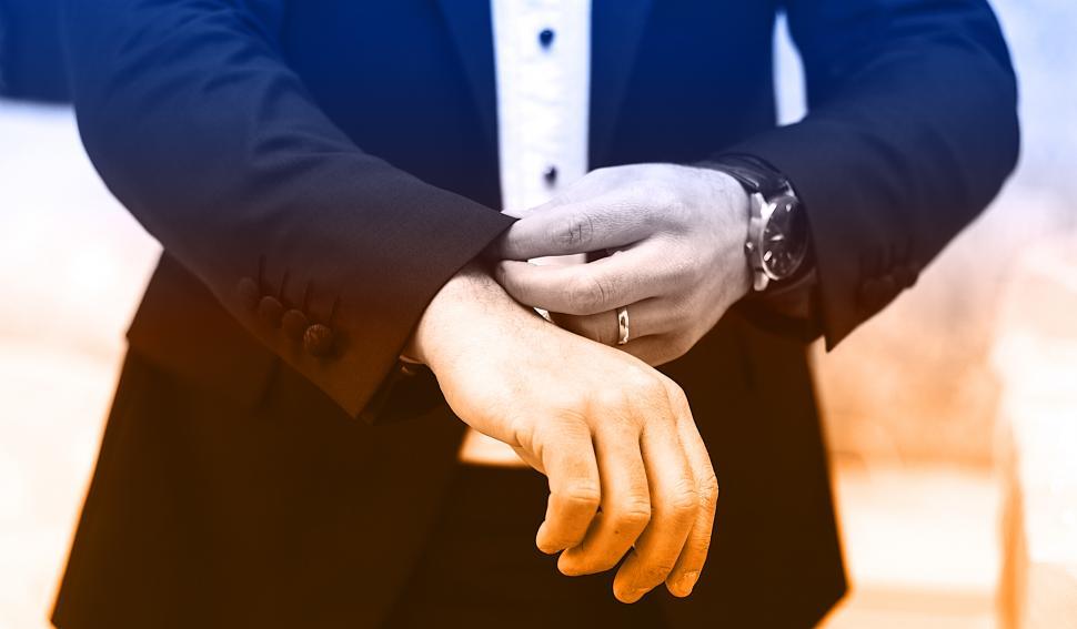 Free Image of Businessman Straightening Shirt 