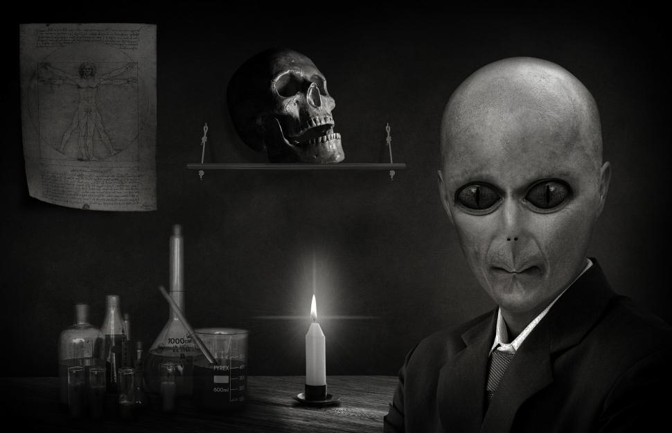Free Image of Creepy Man Holding Candle in Dark Room 