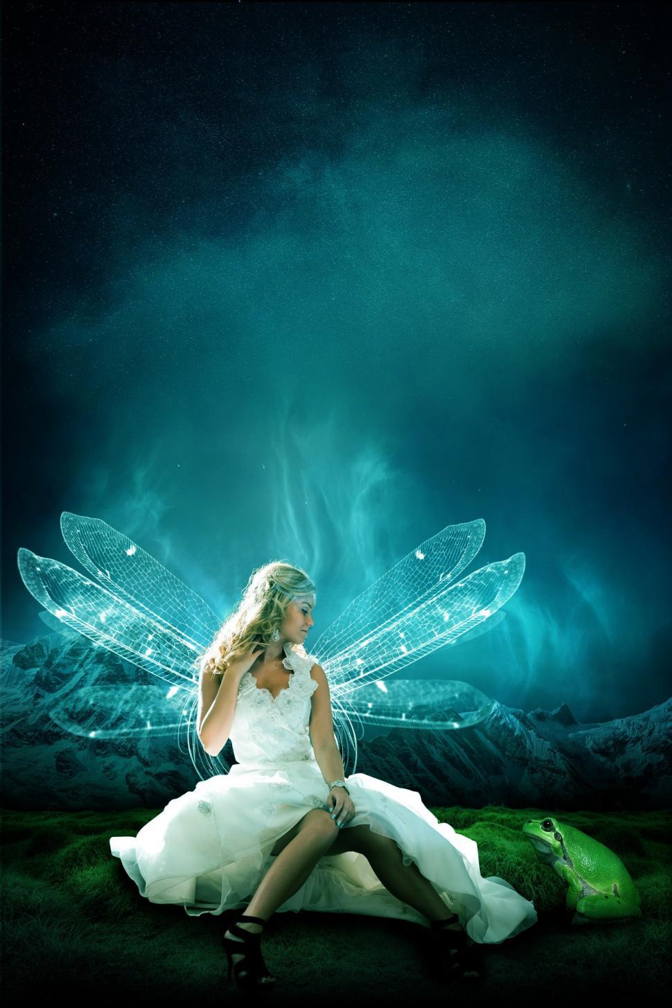 Free Image of Woman in White Dress Sitting on Ground 