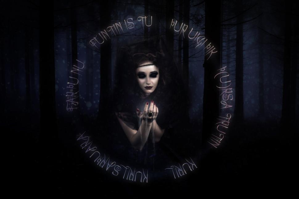 Free Image of Woman Standing in the Dark With Clasped Hands 