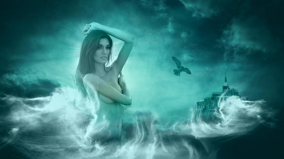 Free Image of Woman Standing in Water With Bird Flying Above 