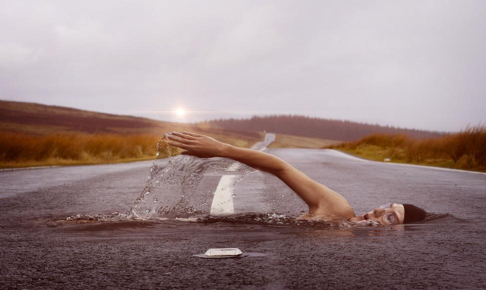 Free Image of Person Laying on Back in Middle of Road 
