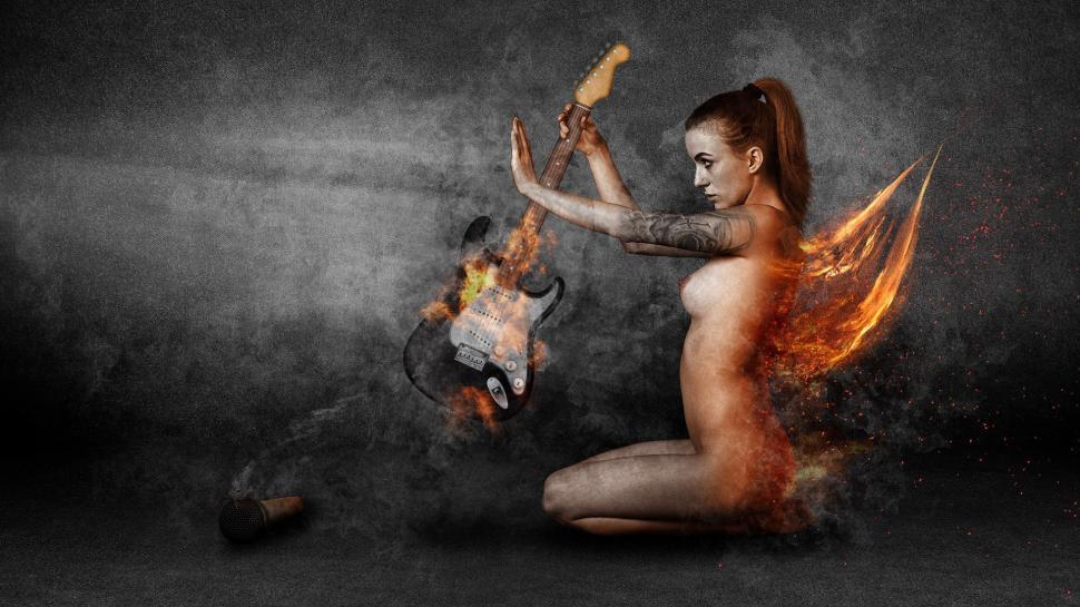 Free Image of Woman Sitting on Ground With Guitar 