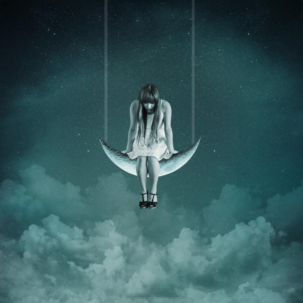 Free Image of Woman Sitting on the Moon in the Sky 