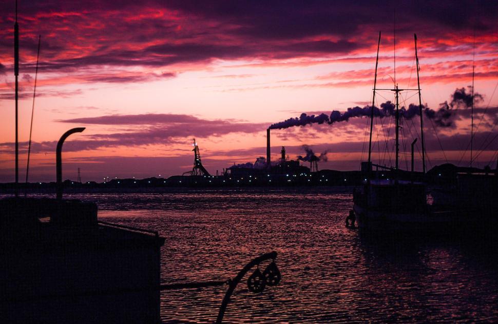 Free Image of Industrial factory smoke from smokestacks over an ocean 
