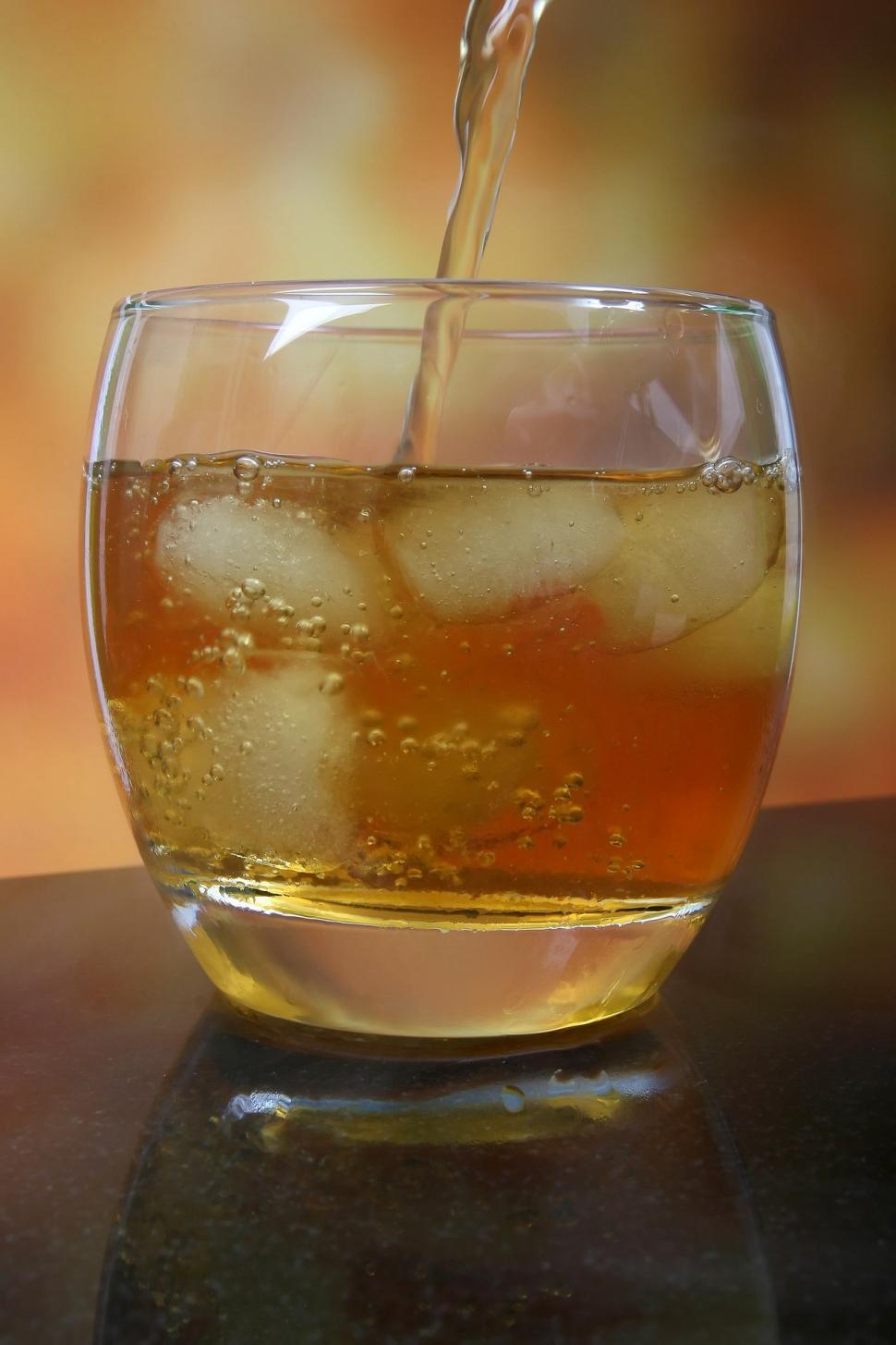 Free Image of Glass Filled With Liquid and Ice on Table 