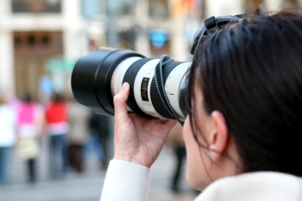 Free Image of Woman Taking a Picture With a Camera 