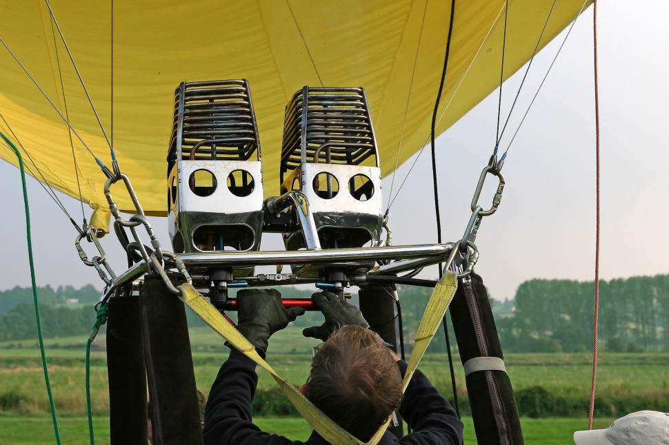 Free Image of Man Working on Large Yellow Hot Air Balloon 