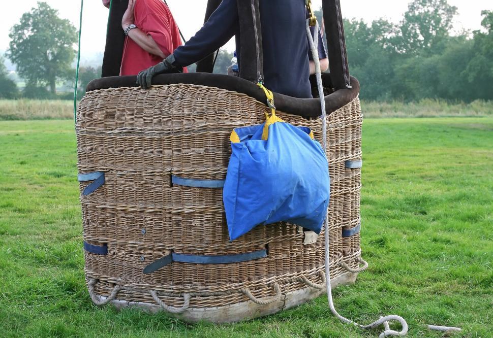 Free Image of Man and Woman Standing Inside Large Basket 