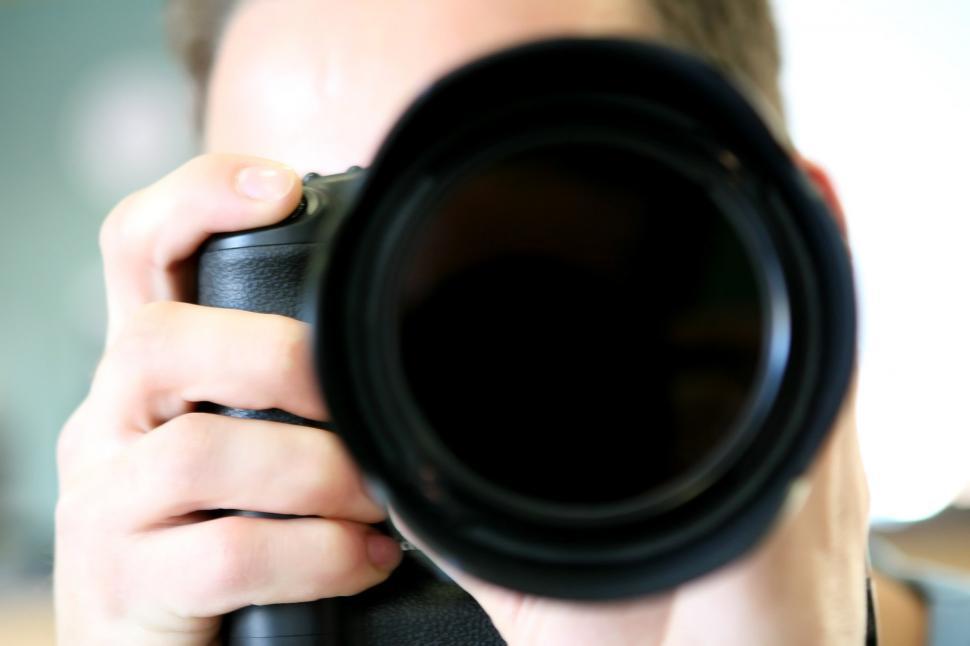 Free Image of Man Holding Camera Up to Face 