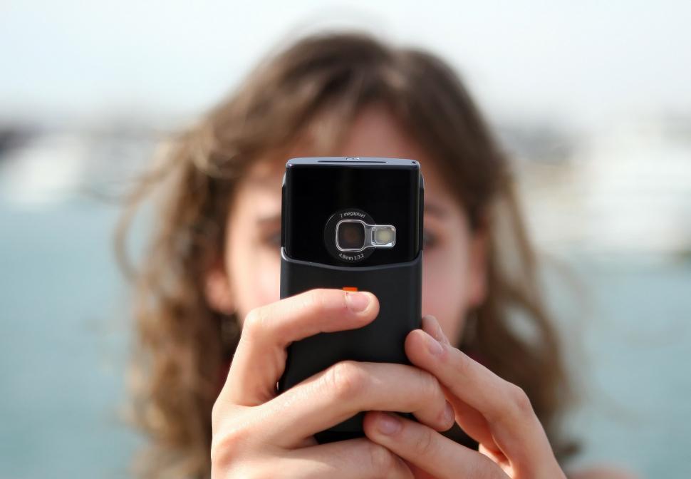 Free Image of Woman Taking a Picture With Her Cell Phone 