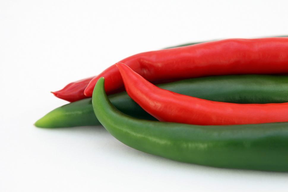Free Image of Green and Red Peppers on White Surface 