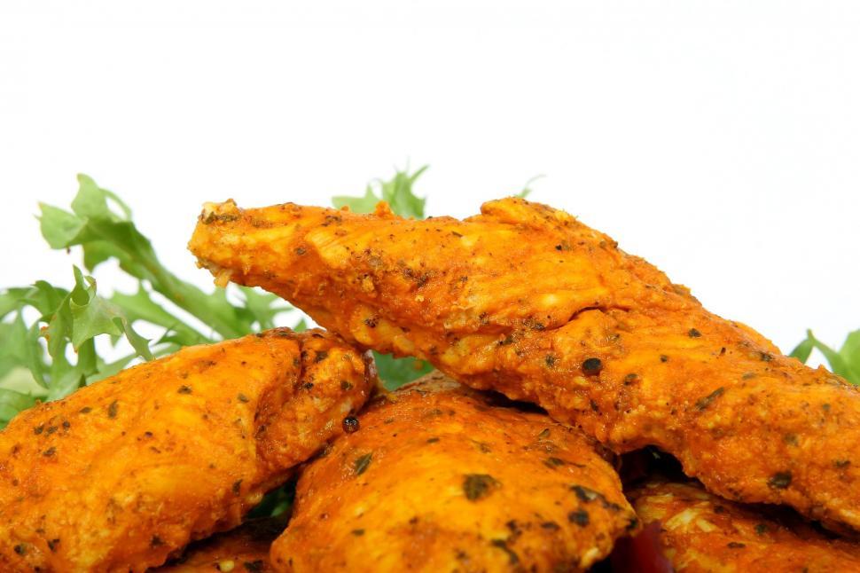 Free Image of A Pile of Fried Chicken on a White Plate 