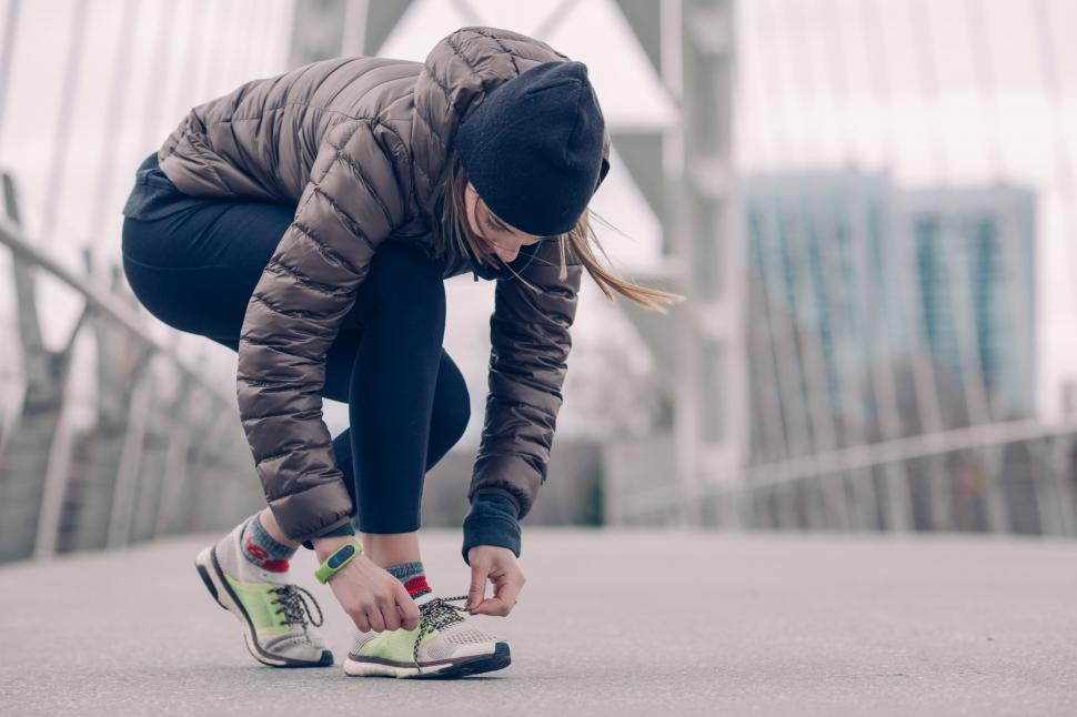 Free Image of Athlete Tying Running Shoes 