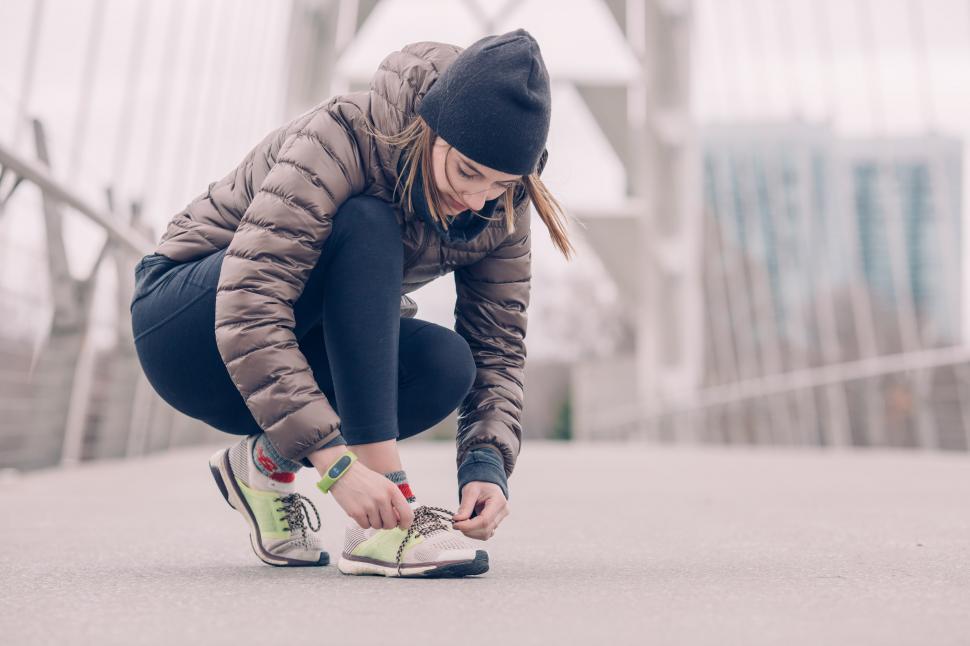 Free Image of Female Athlete Tying Her Shoes 