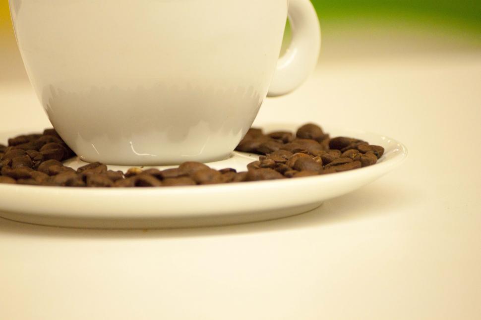 Free Image of Coffee cup with coffee beans 