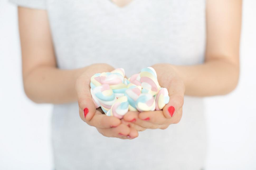 Free Image of Hands Holding Marshmallow Candy 