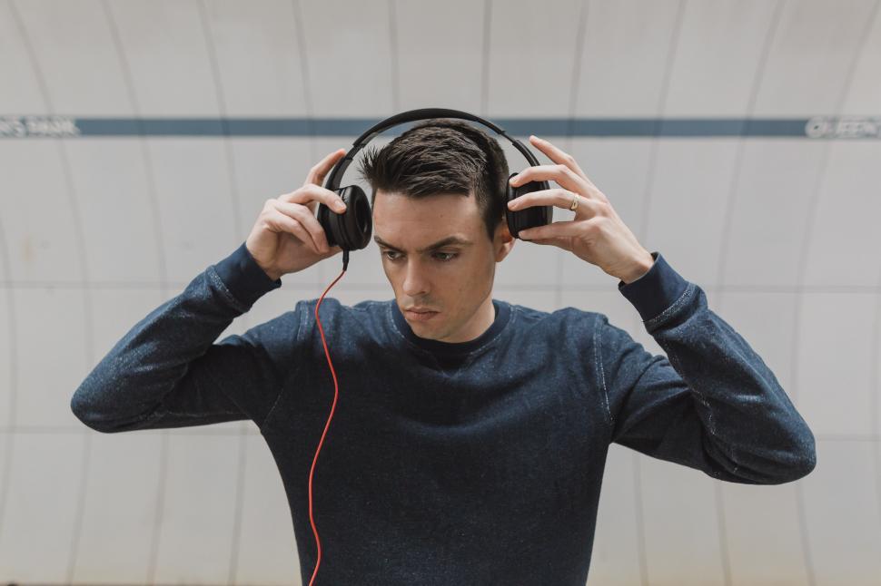 Free Image of Putting On Headphones 