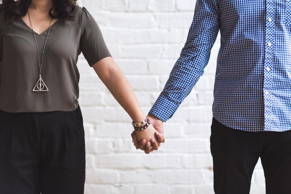 Free Image of Couple Holding Hands 