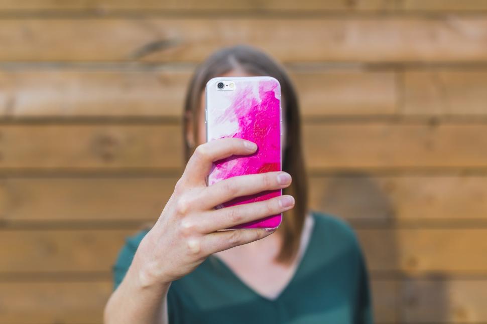 Free Image of Woman Holding Up iPhone 