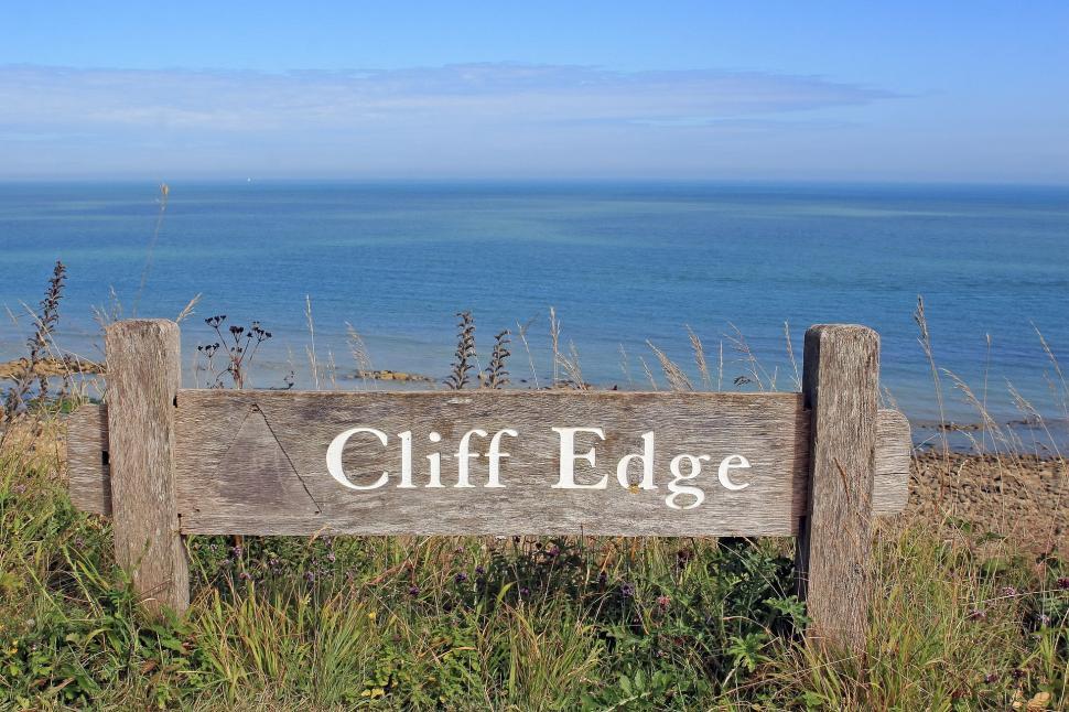 Free Image of Wooden Sign on Lush Green Field 