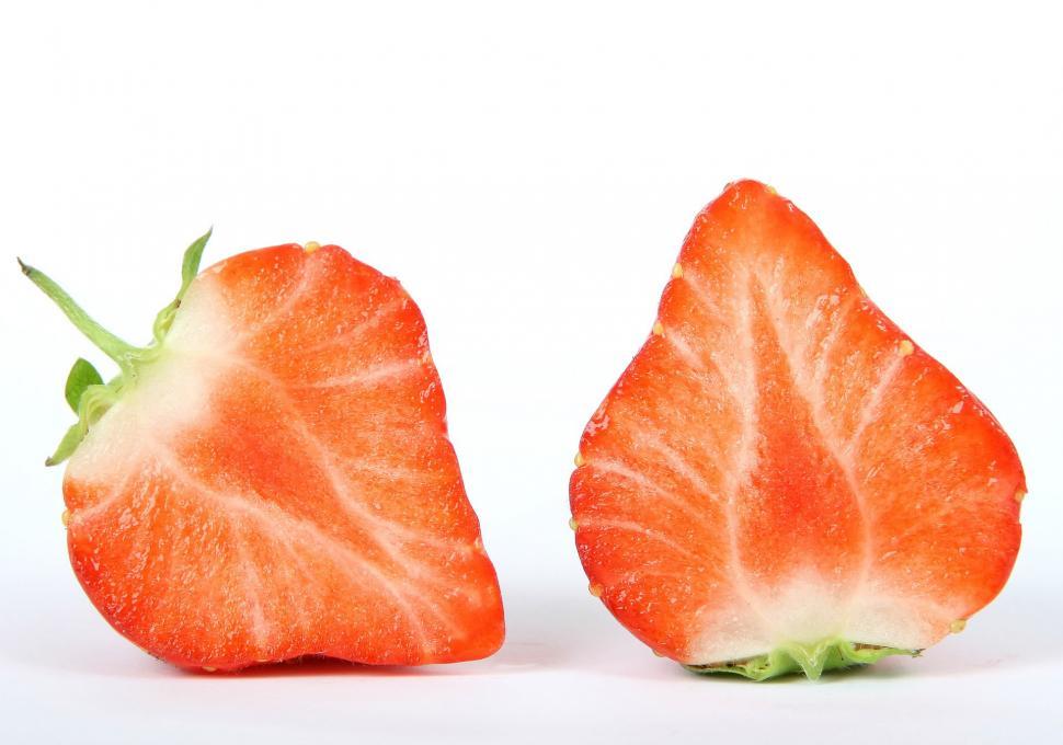 Free Image of Halved Strawberries on White Background 