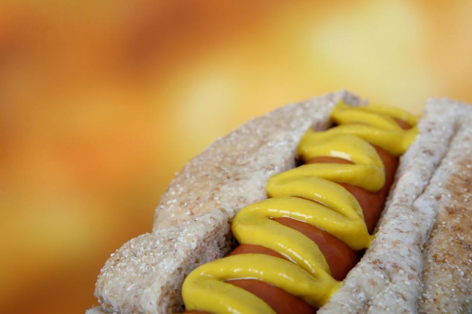 Free Image of Hot Dog With Mustard and Ketchup on a Bun 