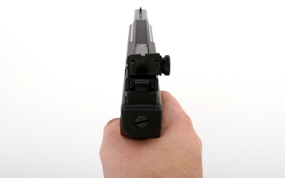 Free Image of Hand Holding Gun on White Background 