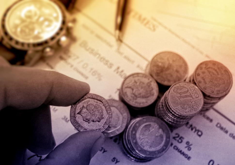 Free Image of Person Picking a Coin - Money and Finance Concept 