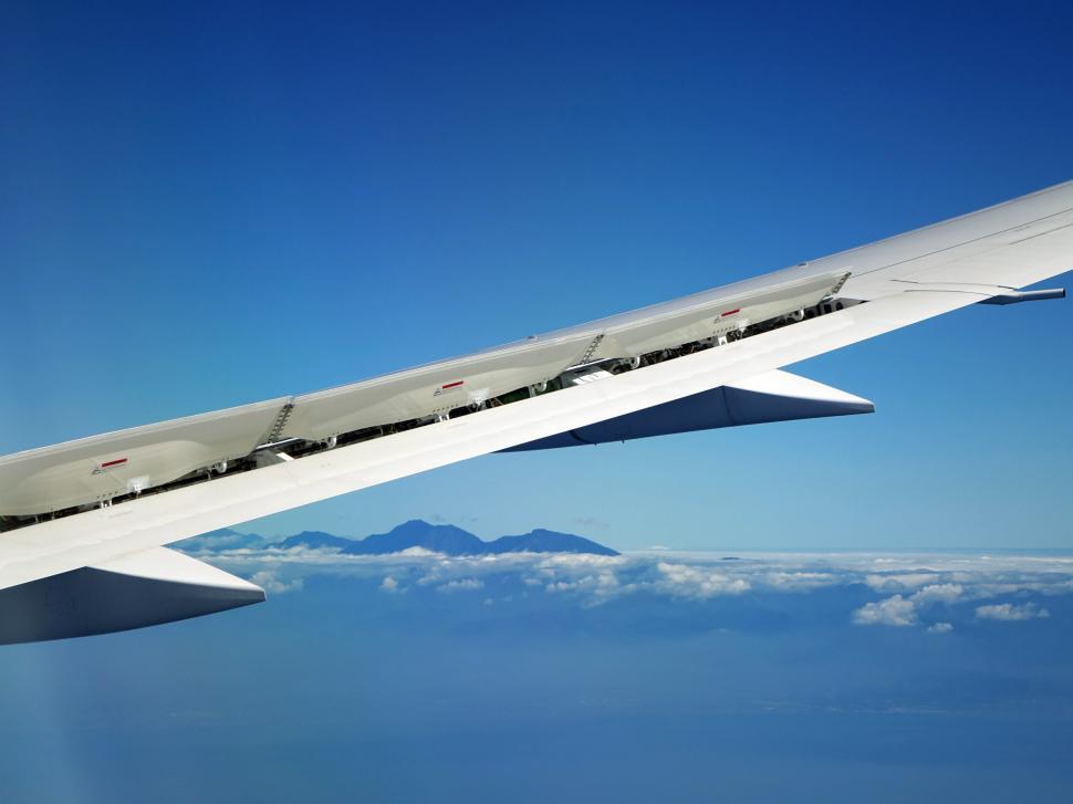 Free Image of Airplane Wing Soaring Above Clouds 