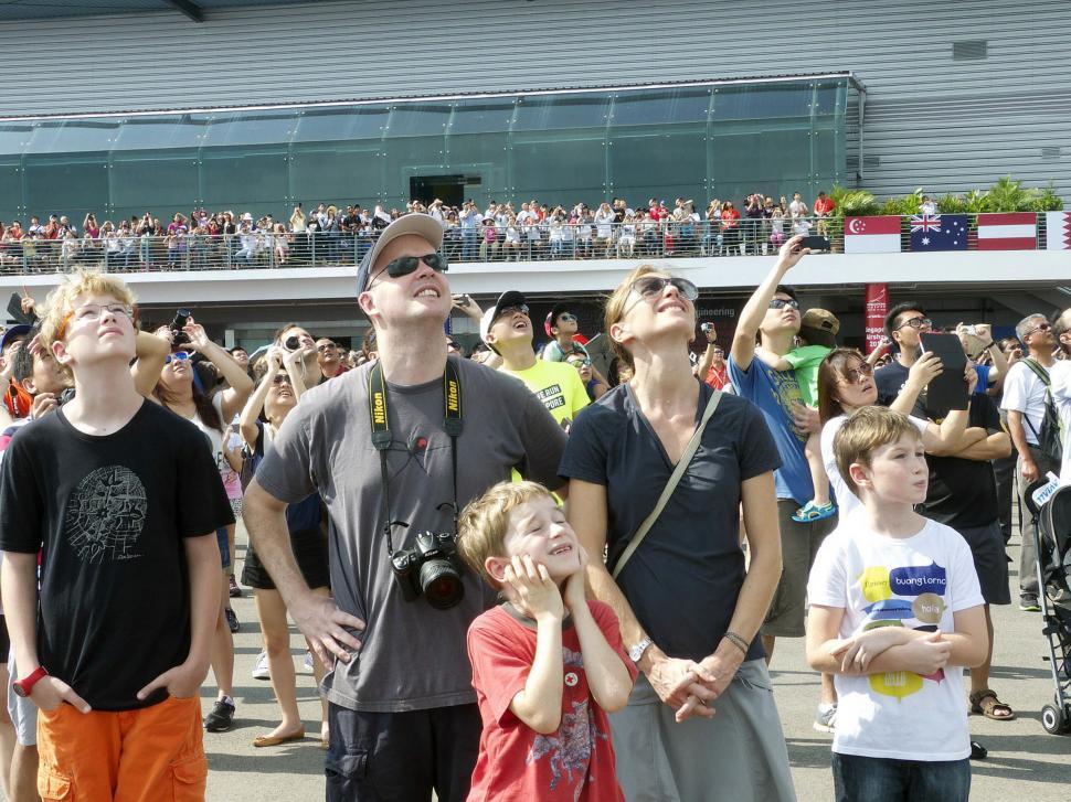 Free Image of Group of People Standing in Front of a Stadium 