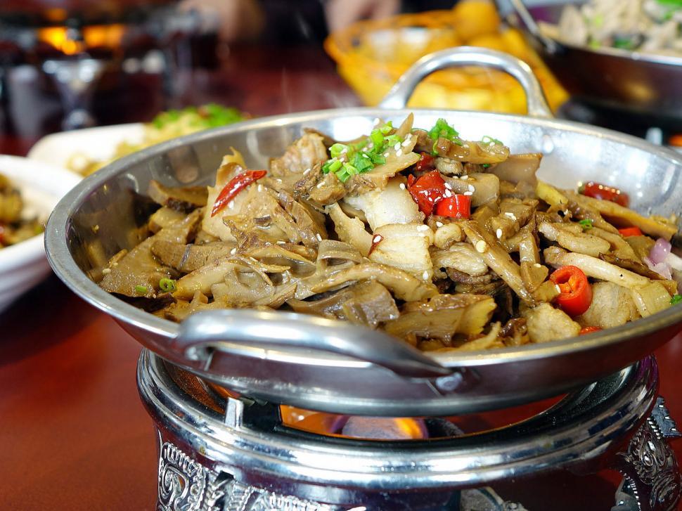 Free Image of Silver Bowl Filled With Food on Wooden Table 