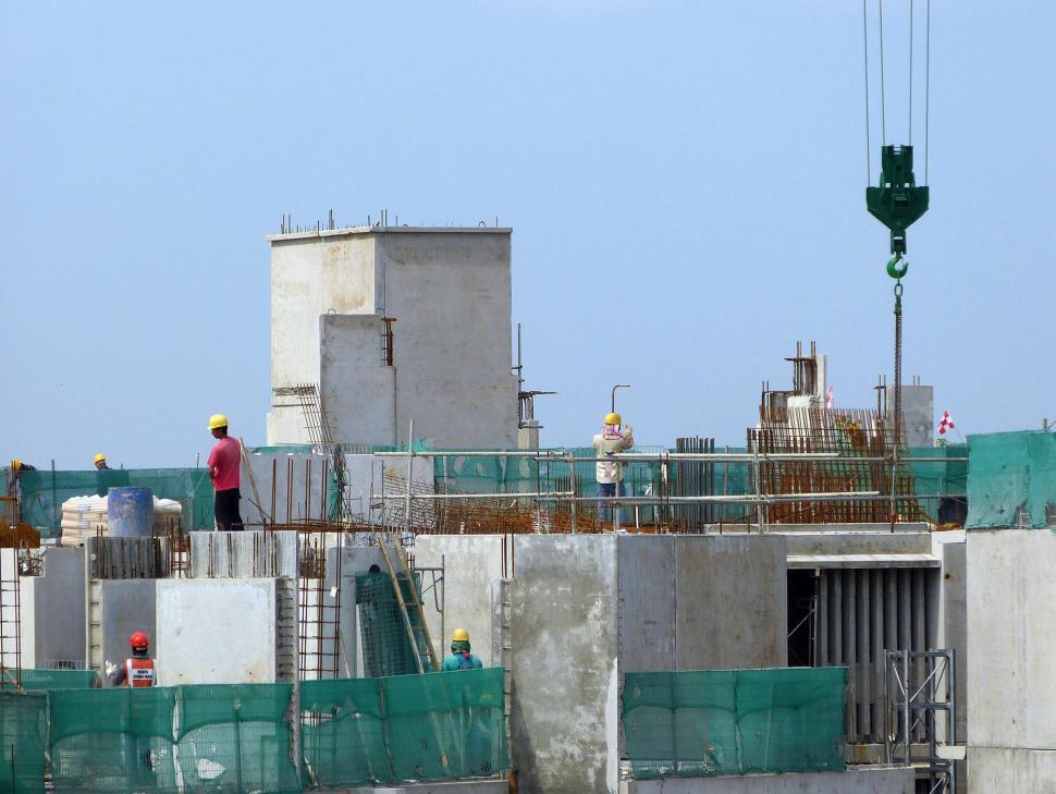 Free Image of Man Standing on Top of Building Under Construction 