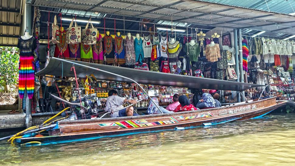 Free Image of Boat With People Floating on Body of Water 
