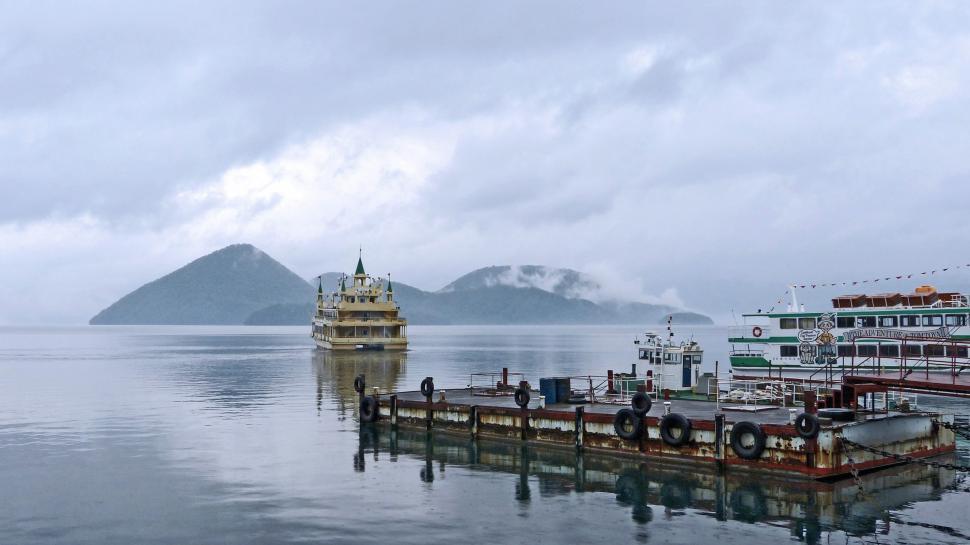 Free Image of Large Boat Floating on Top of a Large Body of Water 