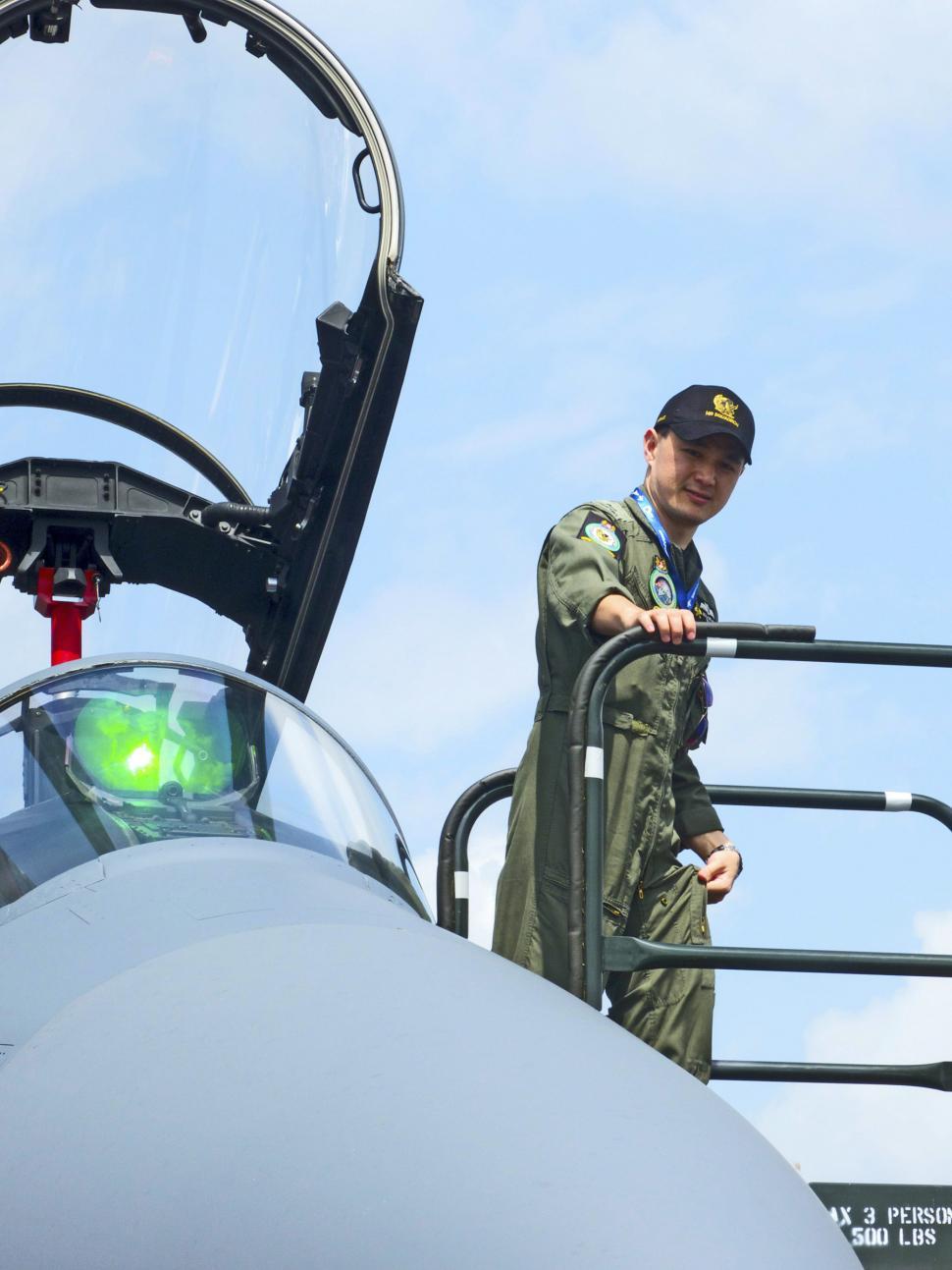 Free Image of Man Standing Next to Fighter Jet 