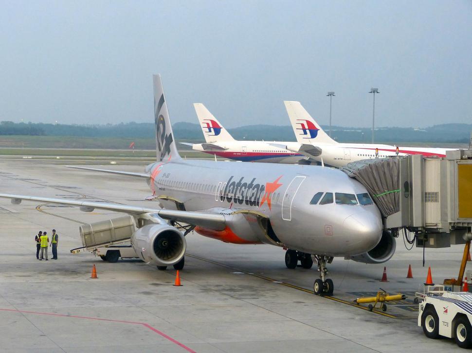 Free Image of Large Jetliner Parked on Airport Tarmac 