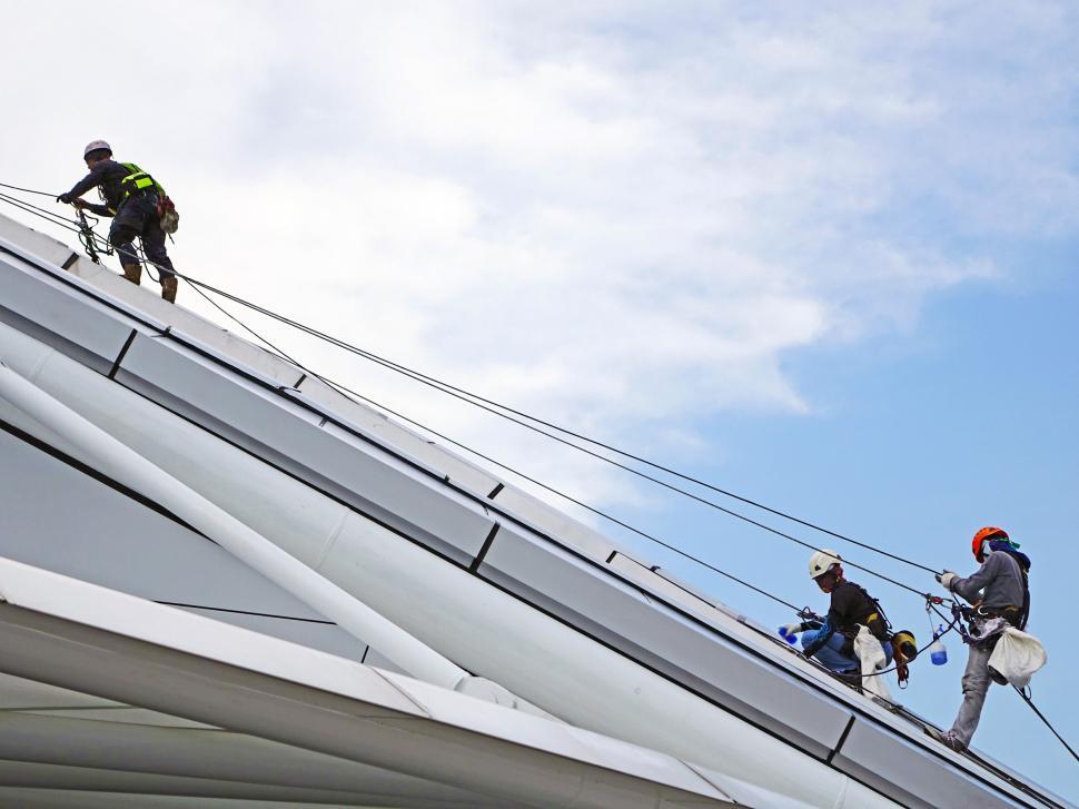 Free Image of Group of People Climbing Up Side of Building 