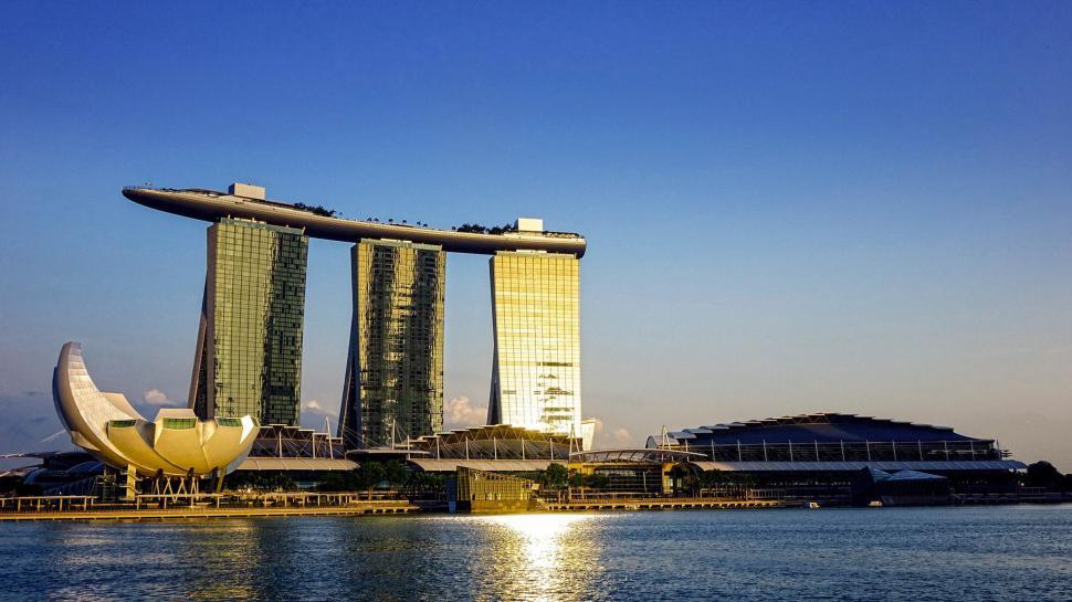 Free Image of Urban Skyline Overlooking a Vast Body of Water 