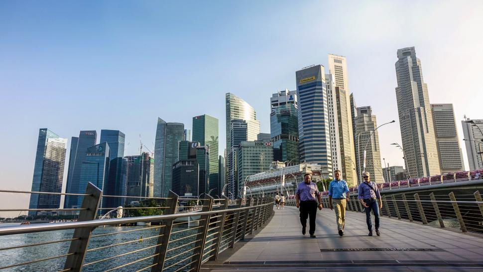 Free Image of Group of People Walking Across a Bridge 