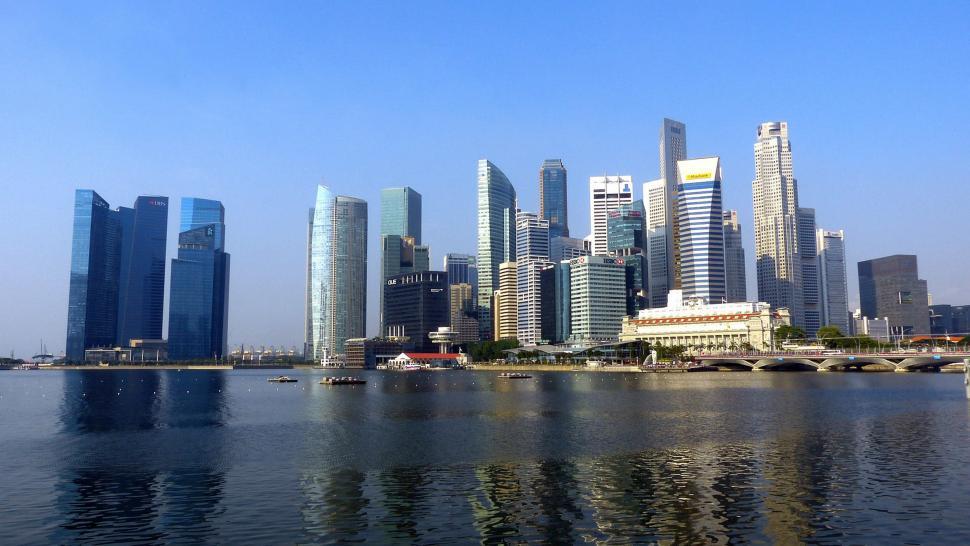 Free Image of City Skyline Overlooking Vast Water Body 