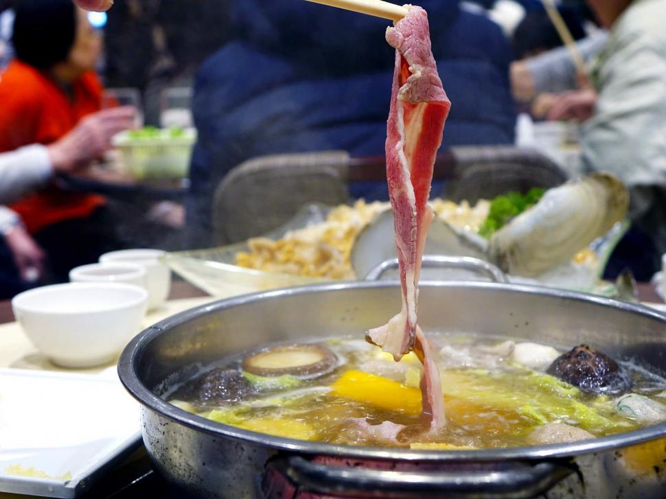 Free Image of Large Pot of Food With Chopsticks 