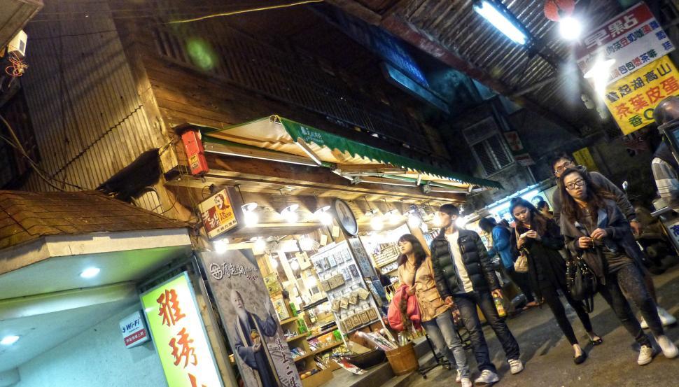 Free Image of Group of People Standing Outside of a Store 