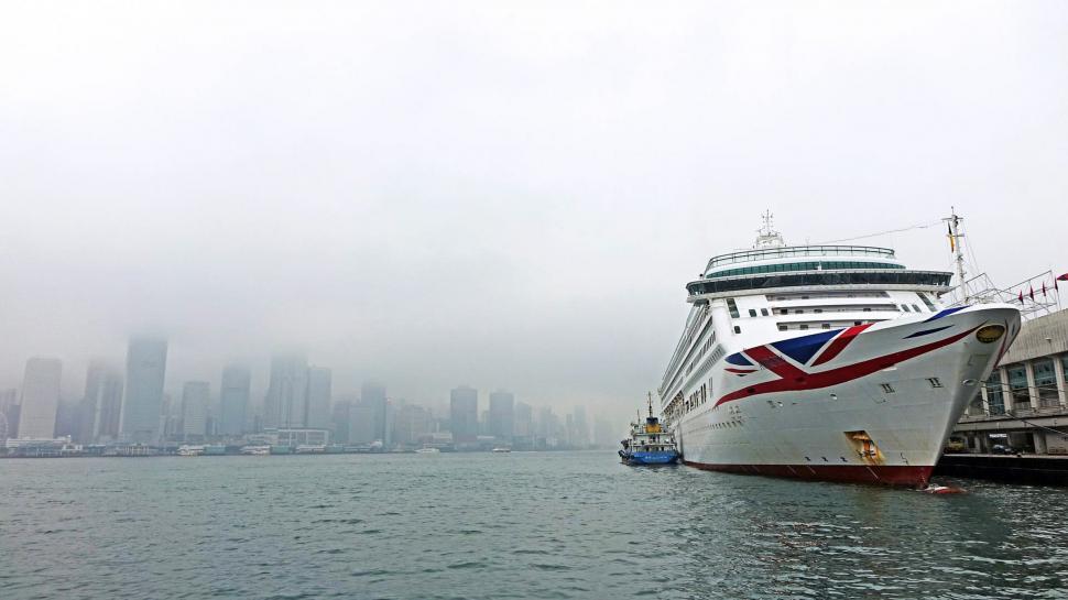 Free Image of Cruise Ship Docked in Harbor With City Background 